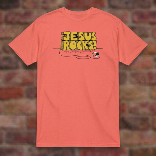 Jesus Rocks T-shirt in Coral Silk, flat lay on blurred brick