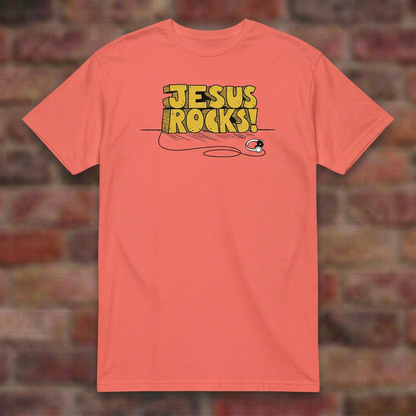 Jesus Rocks T-shirt in Coral Silk, flat lay on blurred brick