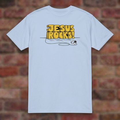 Jesus Rocks T-shirt in Light Blue, flat lay on blurred brick