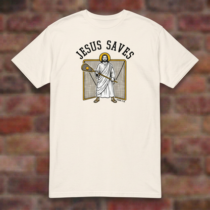 Jesus Saves Lacrosse T-shirt in Natural, flat lay on blurred brick