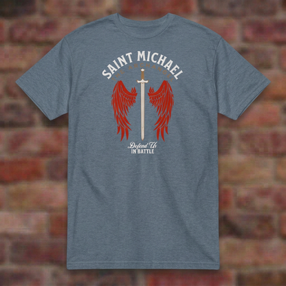 St. Michael Defend Us In Battle T-shirt in Heather Indigo, flat lay on blurred brick